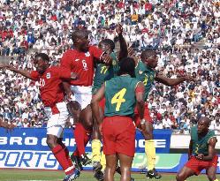 Cameroon, England jump for ball